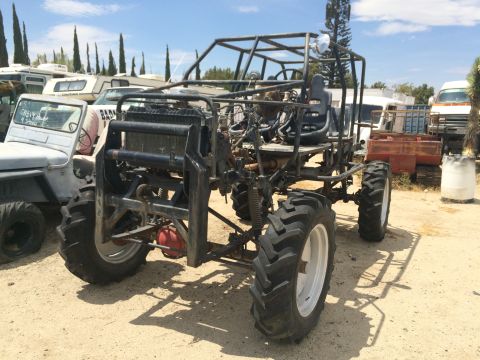 1968 Ford Mustang - Custom buggy with a roll cage and large tires sits in a vehicle lot.