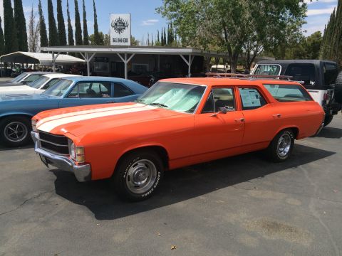 1968 Ford Mustang - An orange 1971 Chevrolet Chevelle station wagon is parked next to other vehicles at a lot.