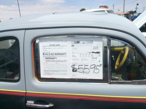 1968 Ford Mustang - This vehicle is displayed with a buyer's guide and price sticker of $55.95 in the window.