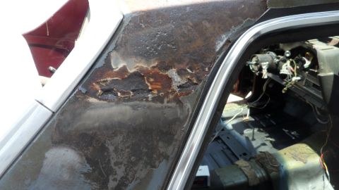 1972 Ford Ranchero - The vehicle's roofline shows significant rust damage, and the interior appears to be stripped down.