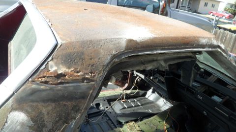 1972 Ford Ranchero - This heavily rusted vehicle interior reveals significant corrosion and exposed wiring, indicating a state of disrepair.