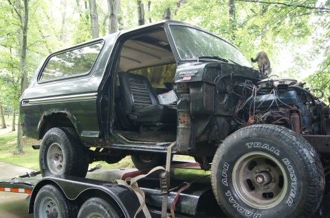 1979 Ford Bronco - This 1979 Ford Bronco is missing its front clip and engine components, sitting on a trailer.