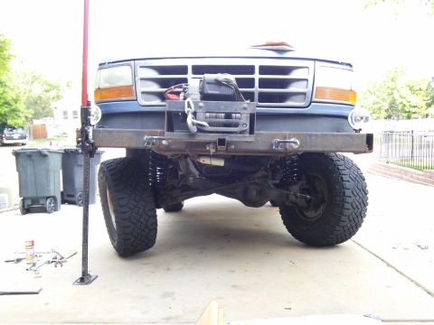 1996 Ford Bronco - This truck features a winch and custom bumper, with a Hi-Lift jack nearby for off-road recovery.