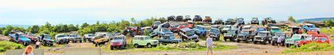 1979 Ford Bronco - A large gathering of off-road vehicles parked on a hillside.