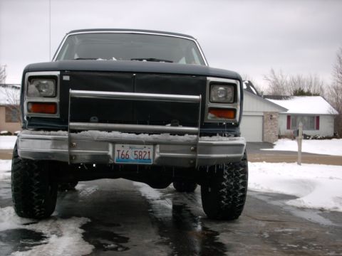 1986 Ford Bronco - Front view of a 1986 Ford Bronco parked in the snow, a chrome bumper and license plate.