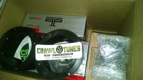 1985 Jeep CJ7 - Car audio parts are packed in a cardboard box, with visible branding from Polk Audio and CrawlTunes.