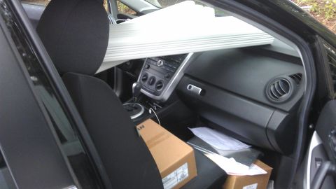 1994 Ford Bronco - Car interior filled with boxes and blinds, obscuring the dashboard and seats.