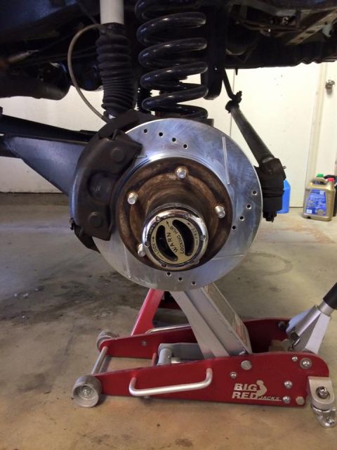 1995 Ford Bronco - Close-up of the front wheel assembly on a 1995 Ford Bronco, showing upgraded braking components.
