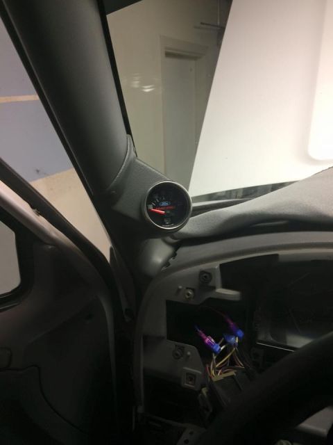 1995 Ford Bronco - A gauge pod is mounted on the A-pillar inside the vehicle, showing a gauge with a red needle.