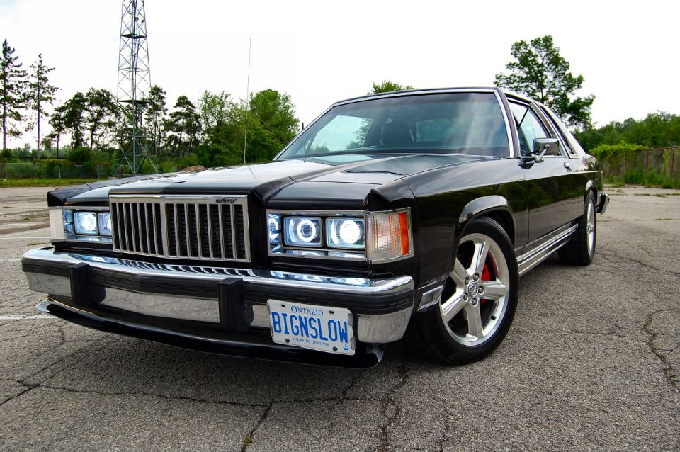 Black 1985 Mercury Grand Marquis with custom headlights and chrome grille