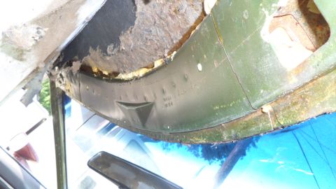 1972 Ford Ranchero - Close-up of damaged interior trim with visible rust and text molded into the plastic.