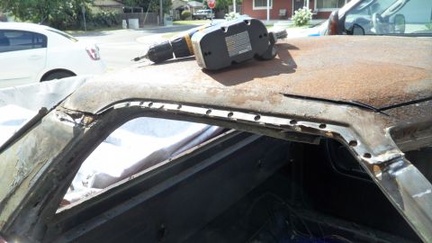 1972 Ford Ranchero - A drill sits on the heavily rusted roof of a vehicle undergoing repairs.