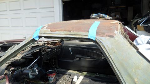 1972 Ford Ranchero - Car interior with a heavily rusted roof, showing the dashboard and door panel.