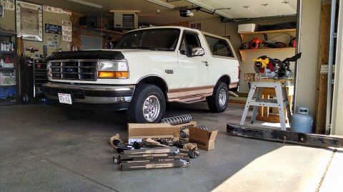 1994 Ford Bronco - 1994 Ford Bronco in garage, parts laid out for installation.