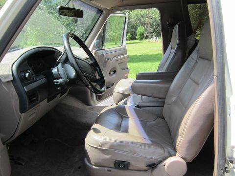 1994 Ford Bronco - Interior view of a 1994 Ford Bronco, tan leather seats and dashboard details.