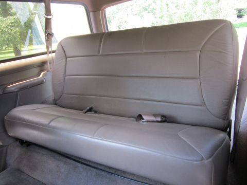 1994 Ford Bronco - Interior view of a vehicle's rear bench seat and seatbelts.