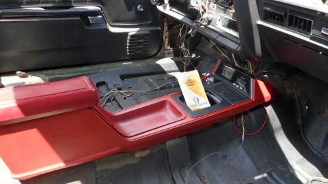 1972 Ford Ranchero - Interior view of a car's center console, showing a manual and exposed wiring.