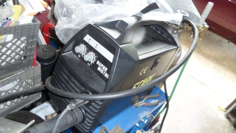 1972 Ford Ranchero - A black welding machine, labeled 'SUPER MIG 180', is visible in a cluttered garage setting.