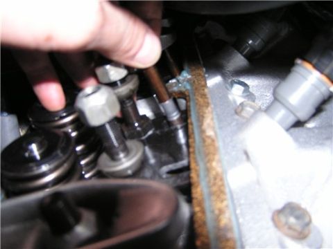 1993 Ford Bronco - Engine valve train components are visible, with a hand interacting with the parts.