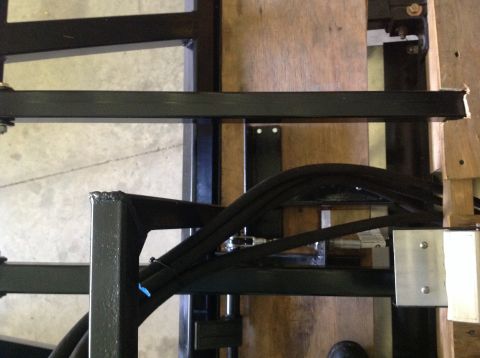 1992 Ford Bronco - Close-up view of a metal frame structure with black hoses and fasteners.