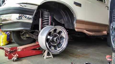 1994 Ford Bronco - 1994 Ford Bronco undergoing suspension work with the front wheel off.