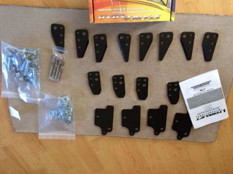 1997 Dodge 3500 - Parts and hardware laid out for installation, including a TorqLift International manual.