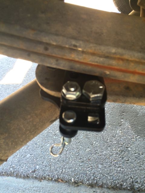 1997 Dodge 3500 - A close-up view of a vehicle's suspension hardware, showing a bracket and bolts.