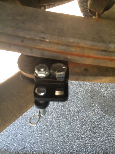 1997 Dodge 3500 - A close-up view of a vehicle's suspension system, focusing on a newly installed bracket.