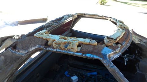 1972 Ford Ranchero - The roof of a vehicle shows significant rust and damage, with expanding foam insulation applied to the frame.