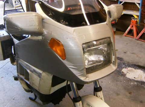 2000 Ford E350 - This motorcycle's front end is heavily covered in tape, obscuring its original appearance and making year identification impossible.