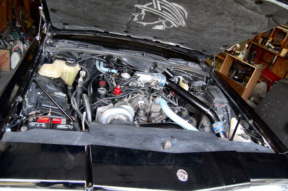 1985 Mercury Grand Marquis engine bay with custom turbocharger and intake piping