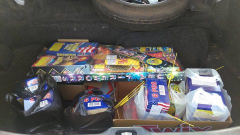 2000 Mercury Grand Marquis - The trunk of a vehicle is filled with various types of fireworks, ready for display.
