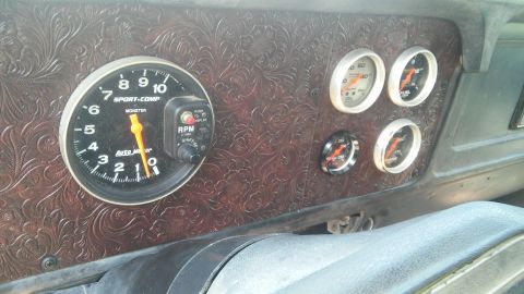 1979 Ford Bronco - Custom dashboard features a large Auto Meter tachometer and additional gauges.