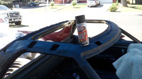 1972 Ford Ranchero - Spray can sits on the A-pillar of a car undergoing restoration. Another vehicle is visible in the background.