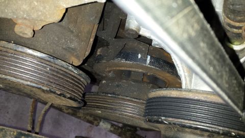 1989 Ford Bronco - Close-up view of engine pulleys and belts, showing wear and some rust.