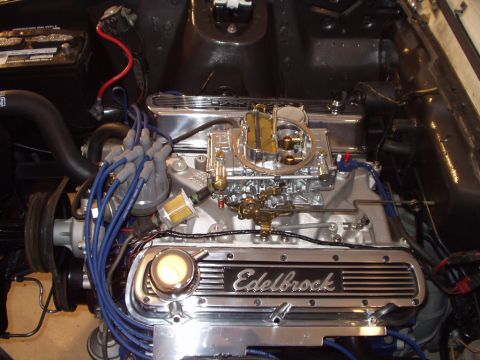 1967 Ford Mustang - Engine bay features polished Edelbrock valve covers and a prominent carburetor, suggesting performance upgrades.