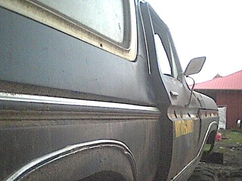 1978 Ford Bronco - Side view of a 1978 Ford Bronco with chrome trim and a yellow decal on the door.