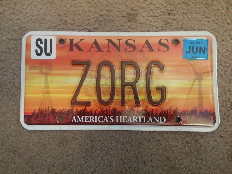 Kansas license plate reading ZORG with sunset windmill graphic