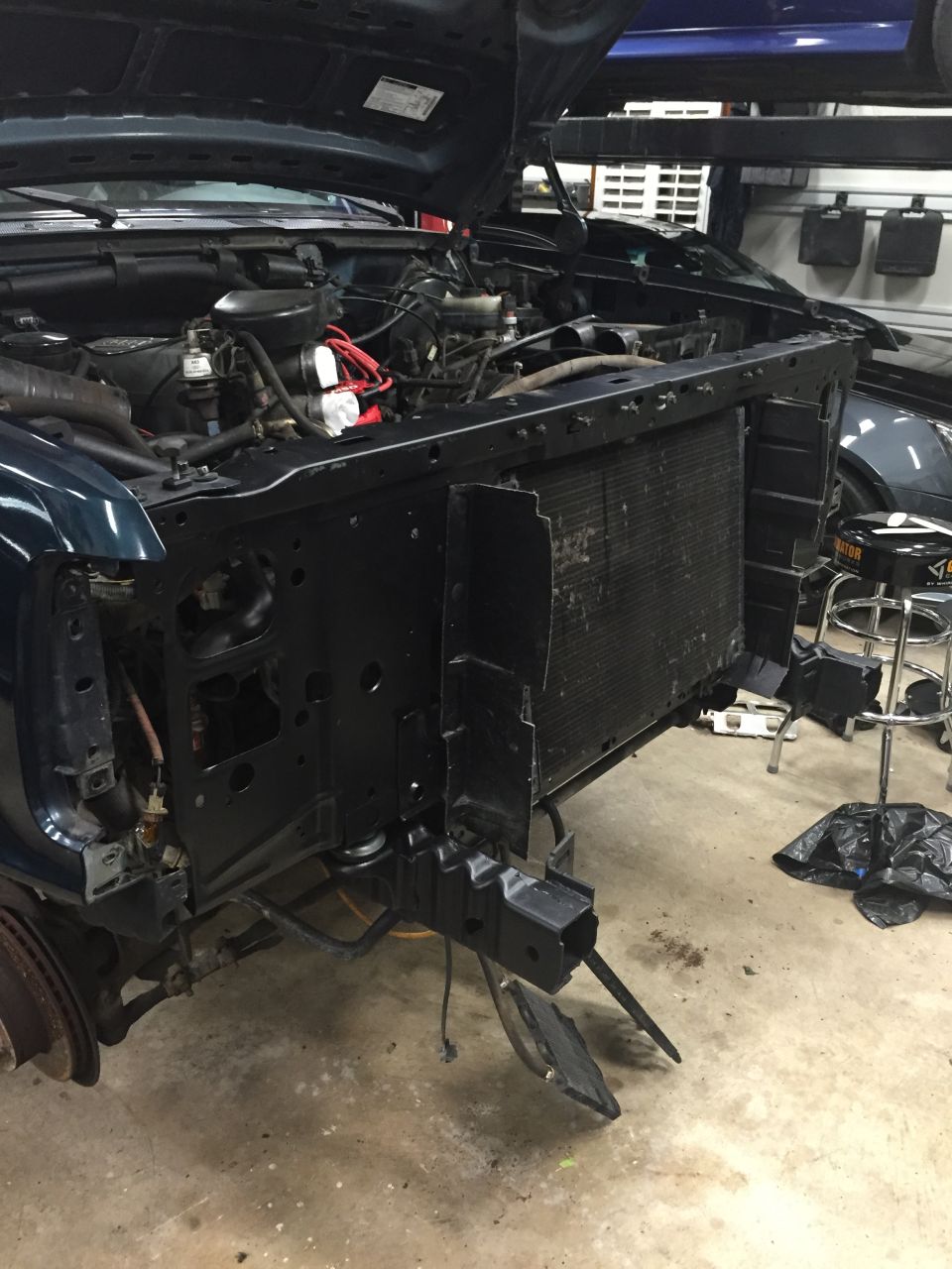 1994 Ford Bronco front end with hood open, radiator removed, engine bay visible.