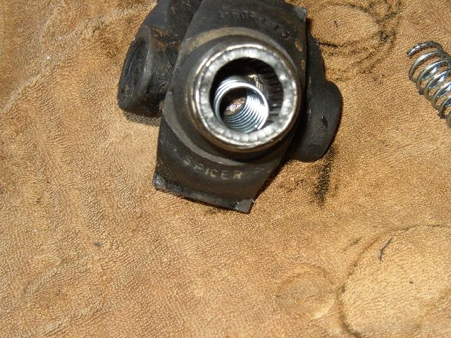 Close-up of a black Spicer driveline yoke showing a threaded bore, on a workbench
