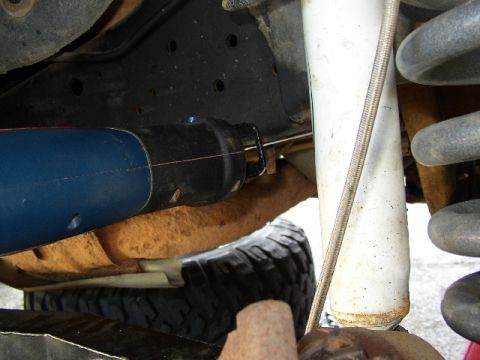 1989 Ford Bronco - A reciprocating saw is used to cut a part of the vehicle's suspension system. The Supermotors.net logo is visible in the lower right corner.