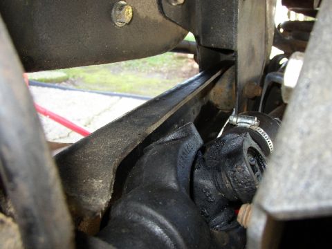1989 Ford Bronco - Close-up view of the front axle and steering components of a vehicle.