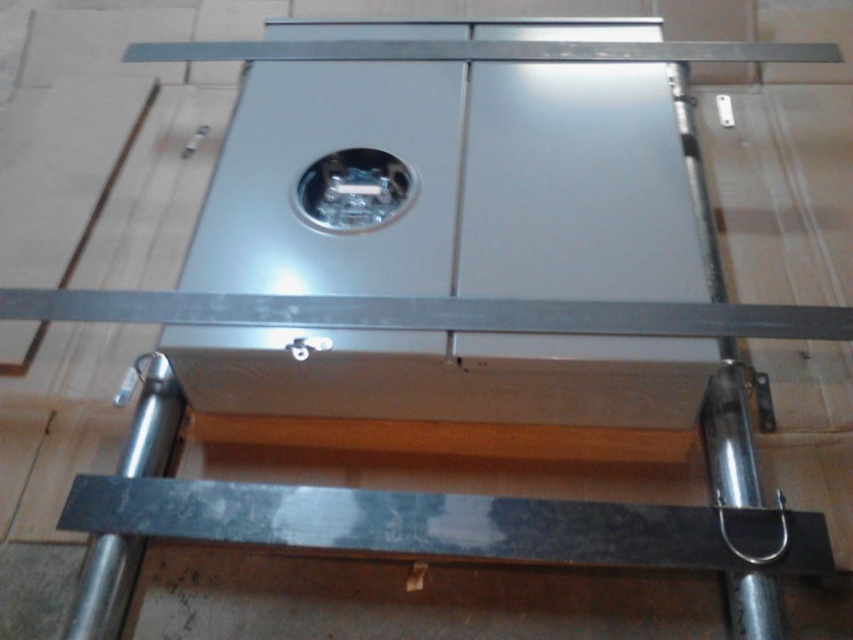 Gray electrical meter box with metal bracing