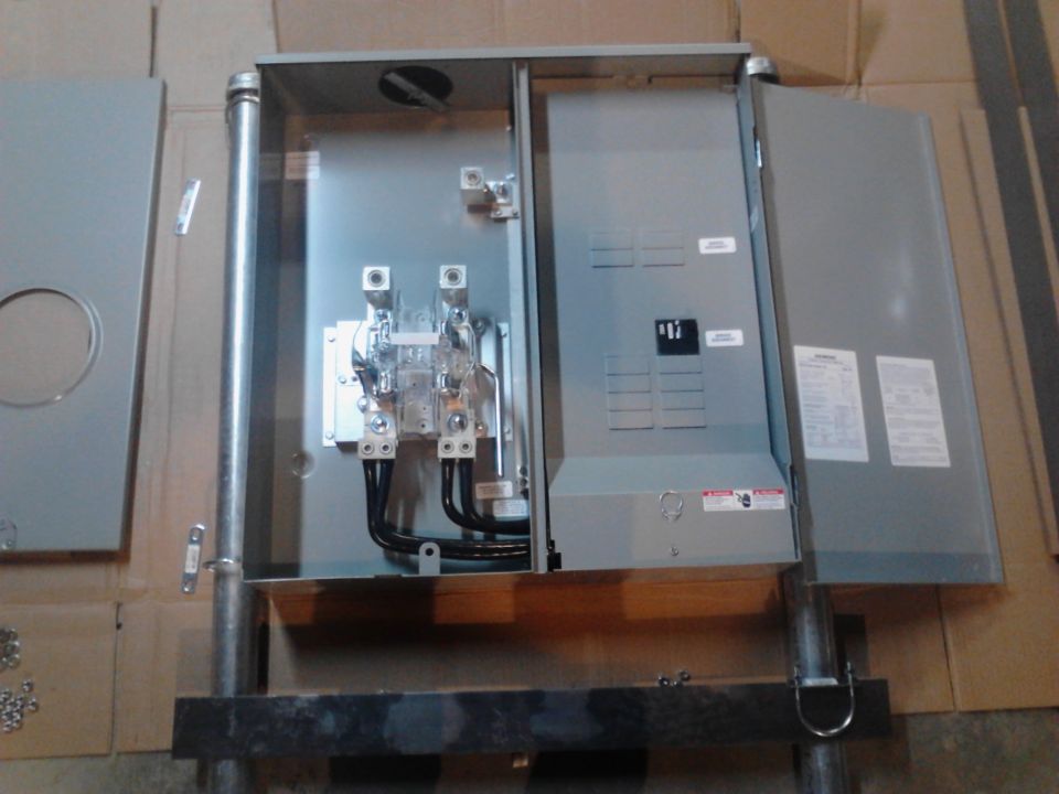 Open electrical panel box with circuit breakers and wiring.