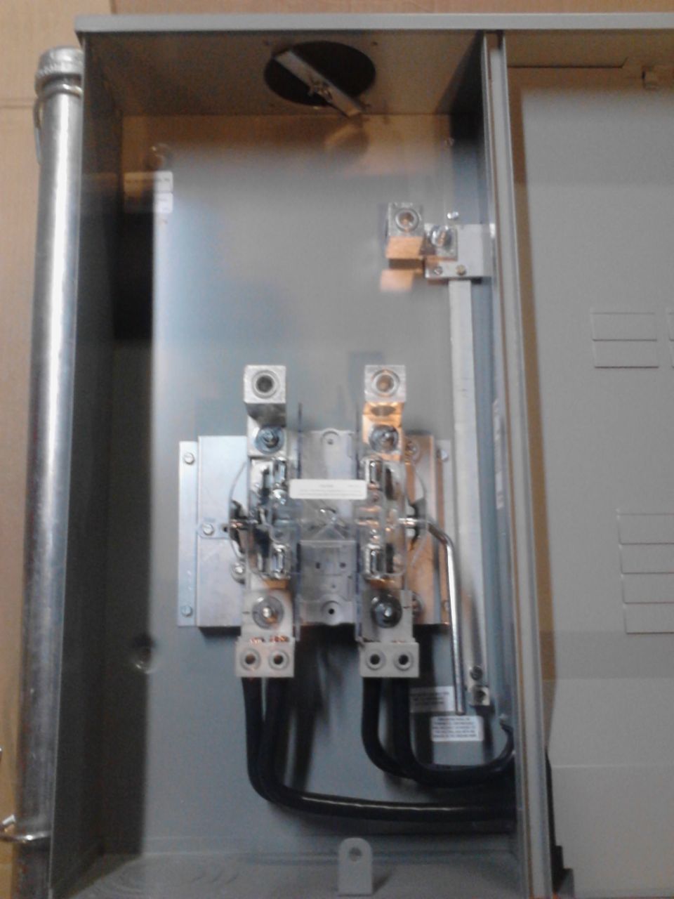 Interior of an electrical panel box with wiring and components.