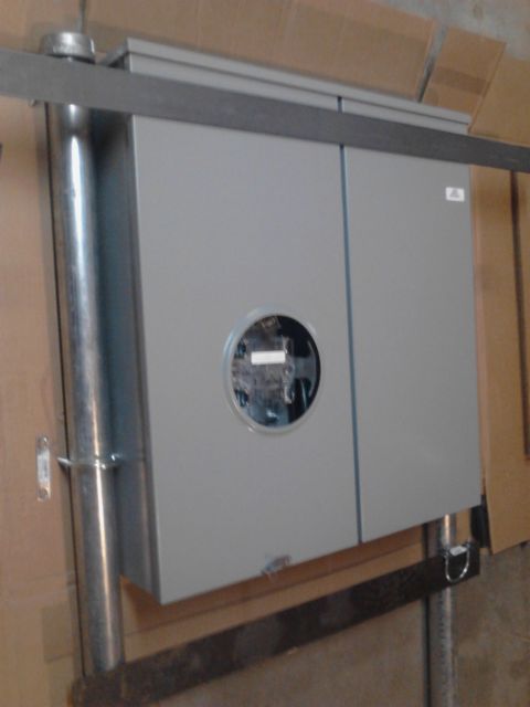 1989 Ford Bronco - A gray electrical panel with a circular meter opening is mounted on a metal conduit pipe. The panel is attached to a horizontal metal brack…