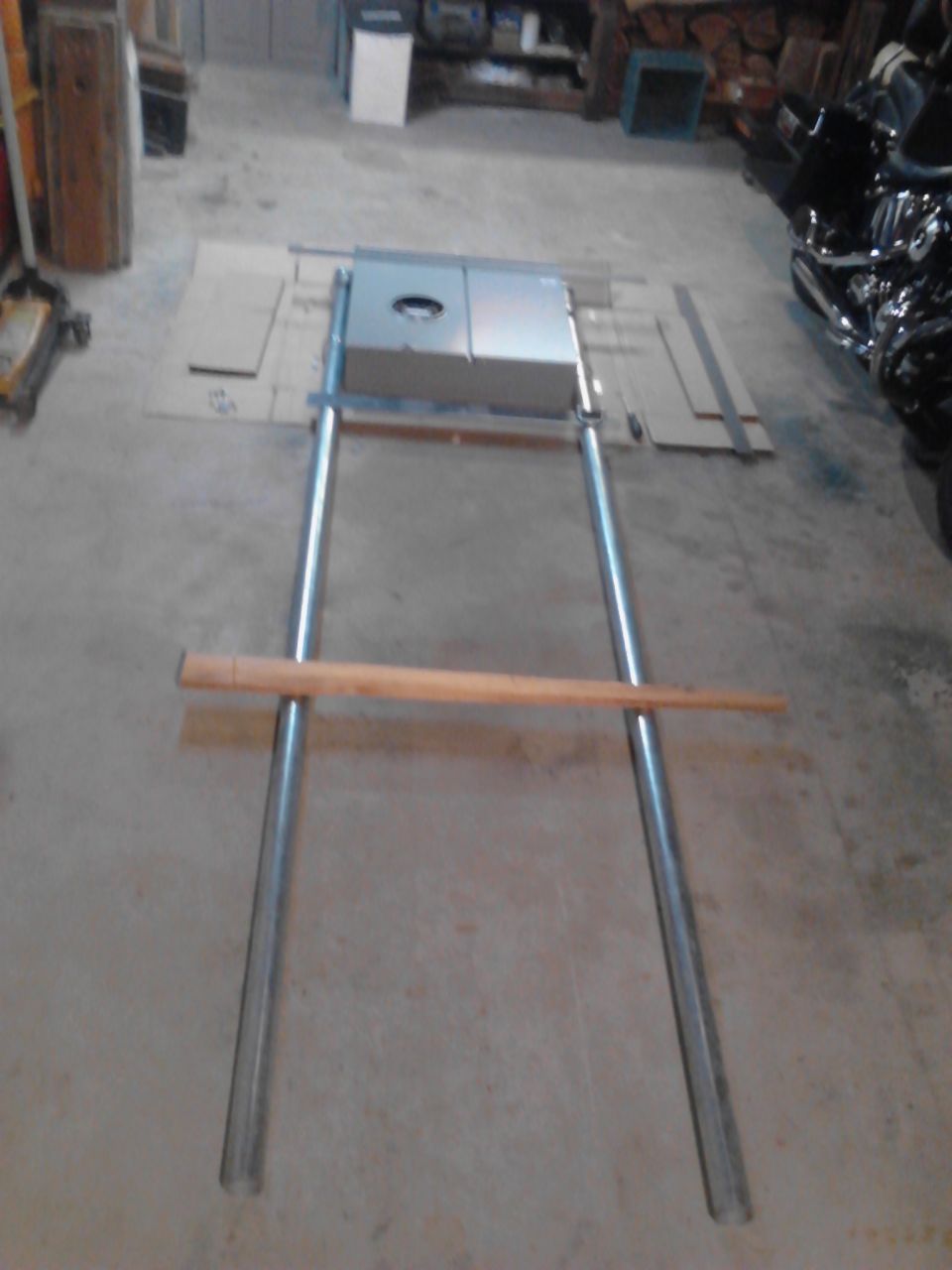 Electrical box on a metal frame with a wooden bar.