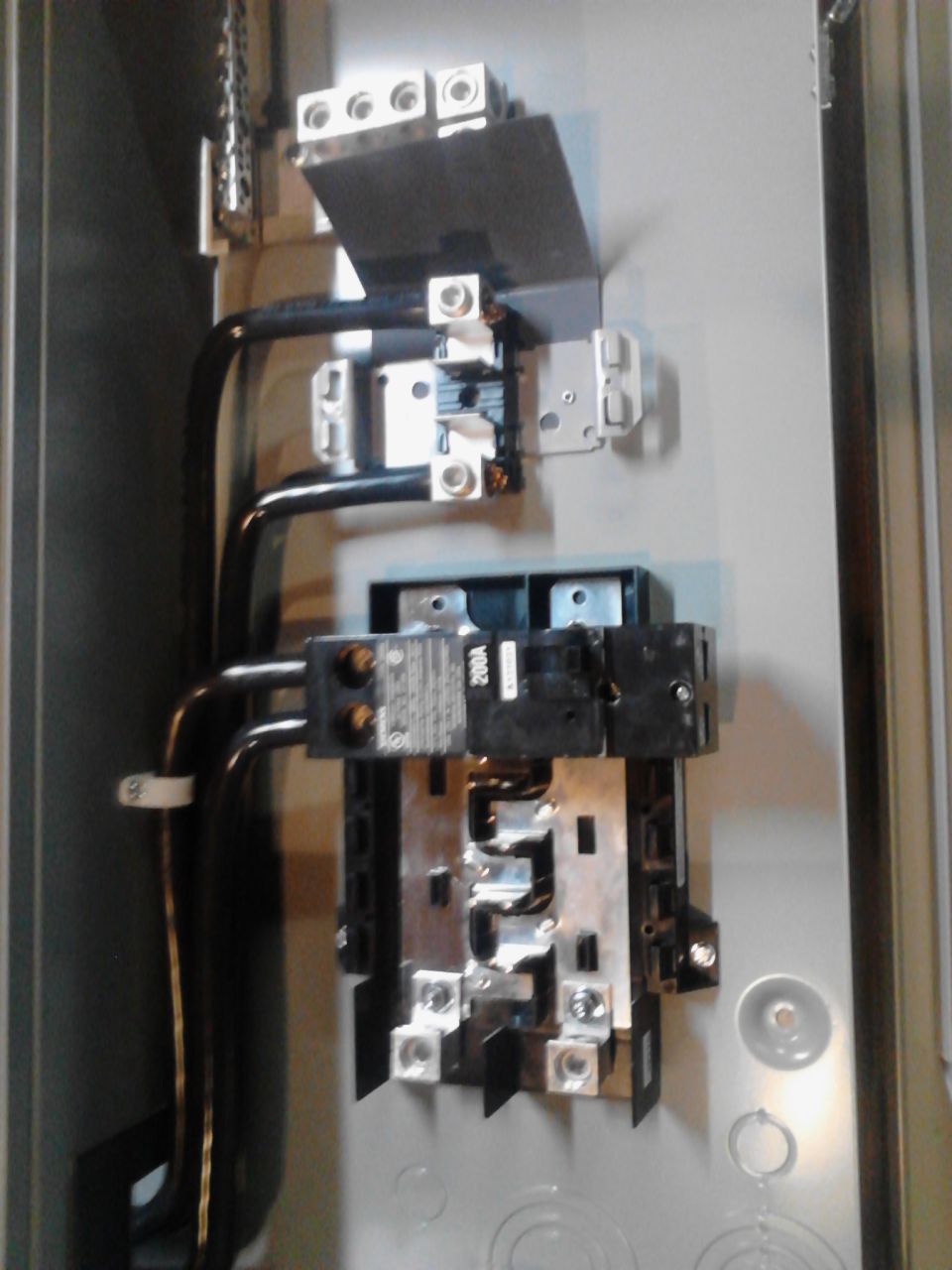 Interior of an electrical panel with circuit breakers and wiring.