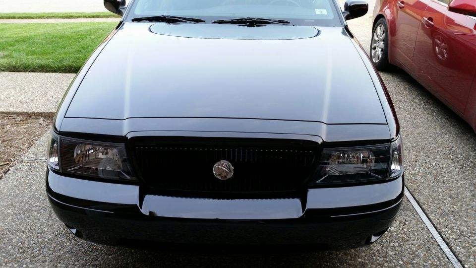 Black Mercury Marauder front view with black grille and tinted headlights.