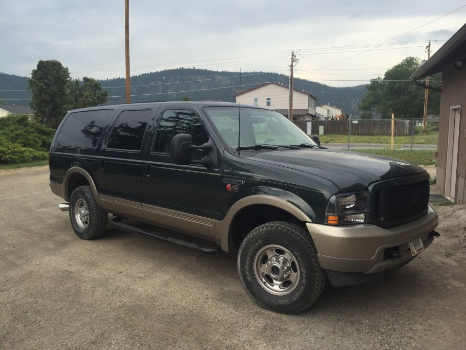 Dark 2003 Ford Excursion SUV, 3/4 front view, parked outdoors on paved surface